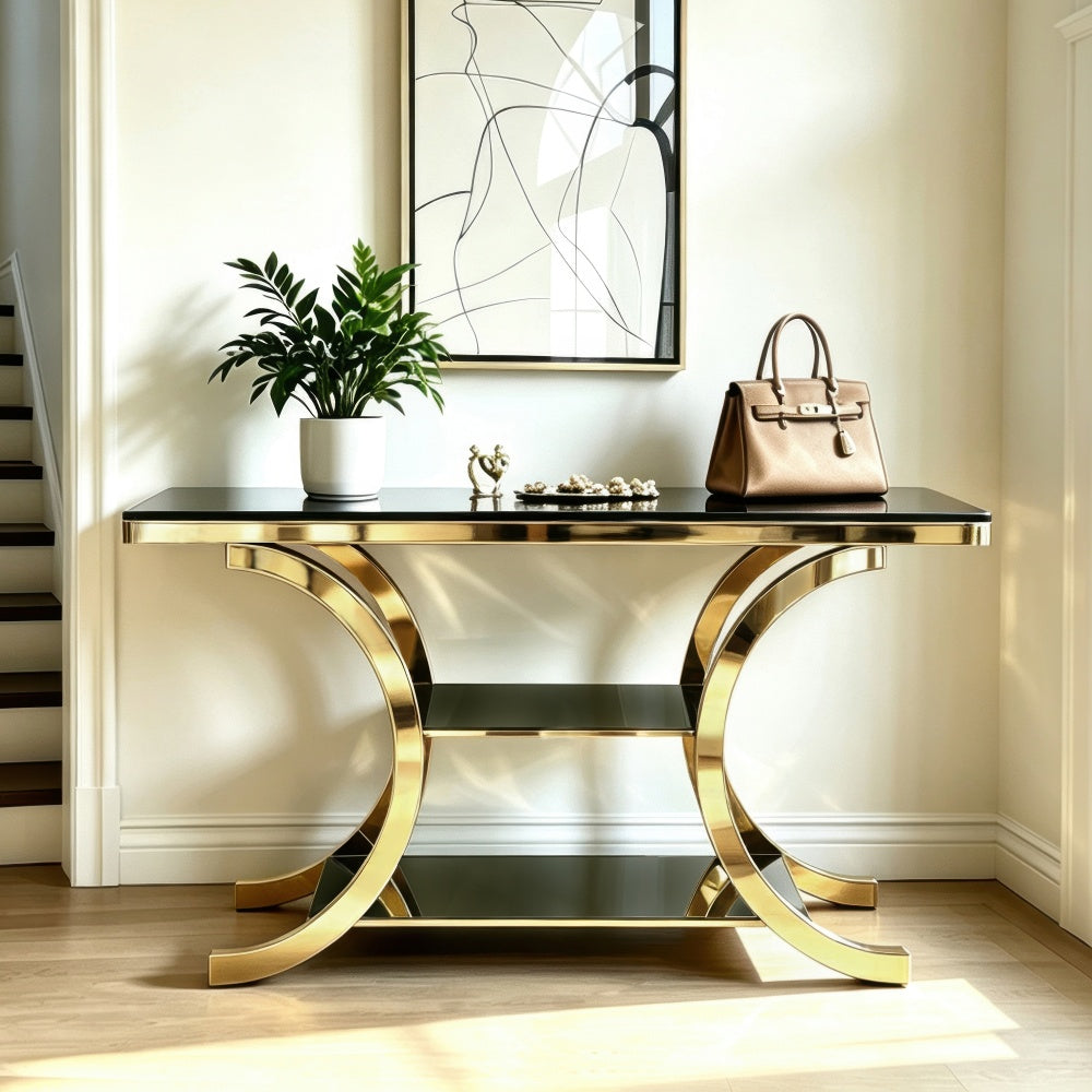 Front view of the gold crescent console showing the black top and two open lower shelves
