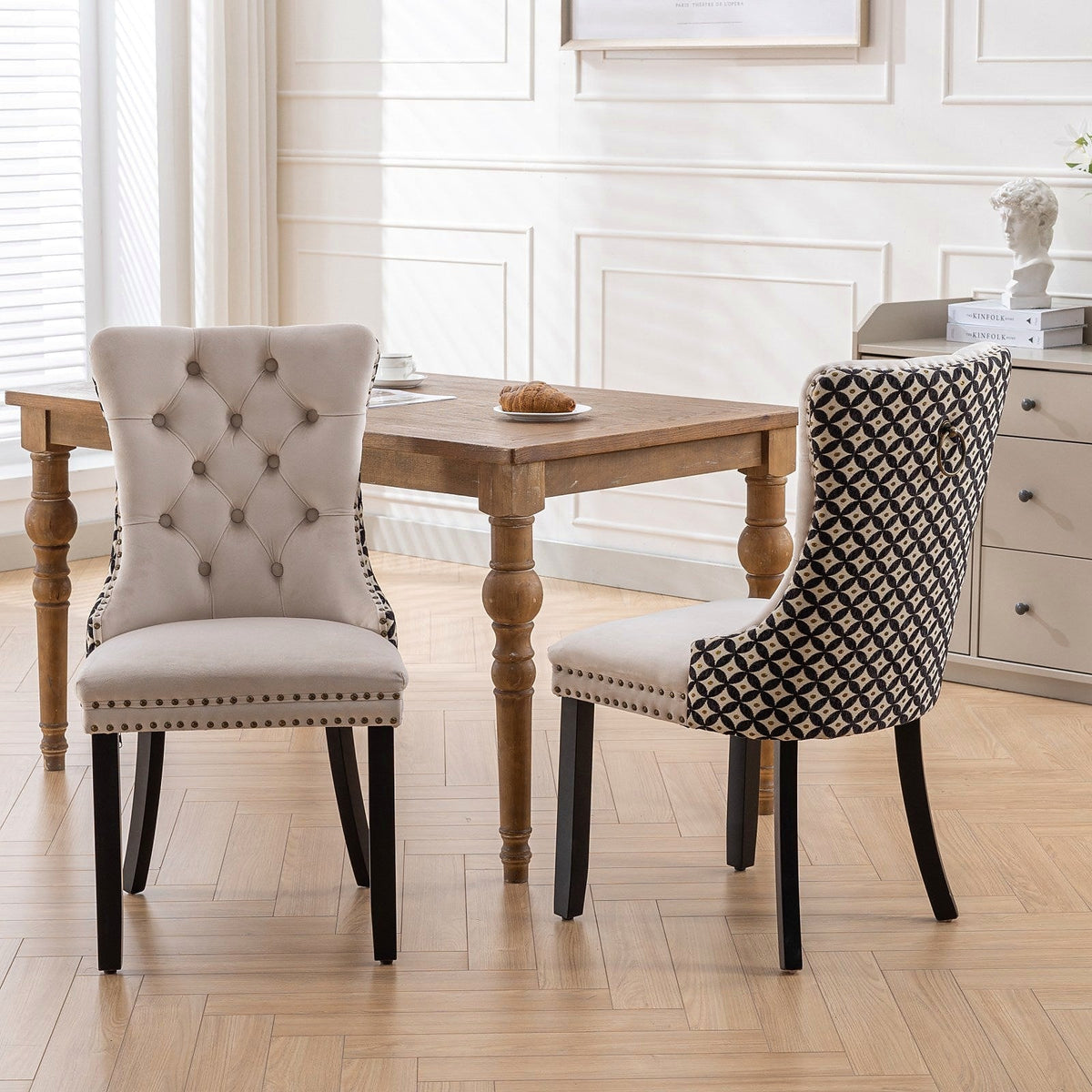 Beige velvet dining chair with a patterned back and dark wood legs