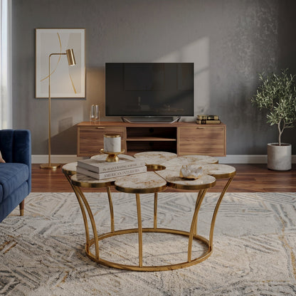 Flower-shaped veined-top coffee table with a gold-tone base in a seating area