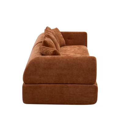 Side view of the orange sofa's deep seat and curved arm