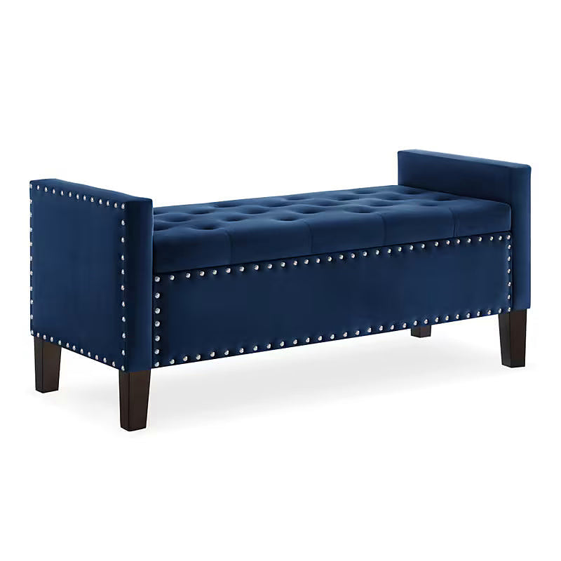 Angled view of the navy tufted storage bench with dark legs
