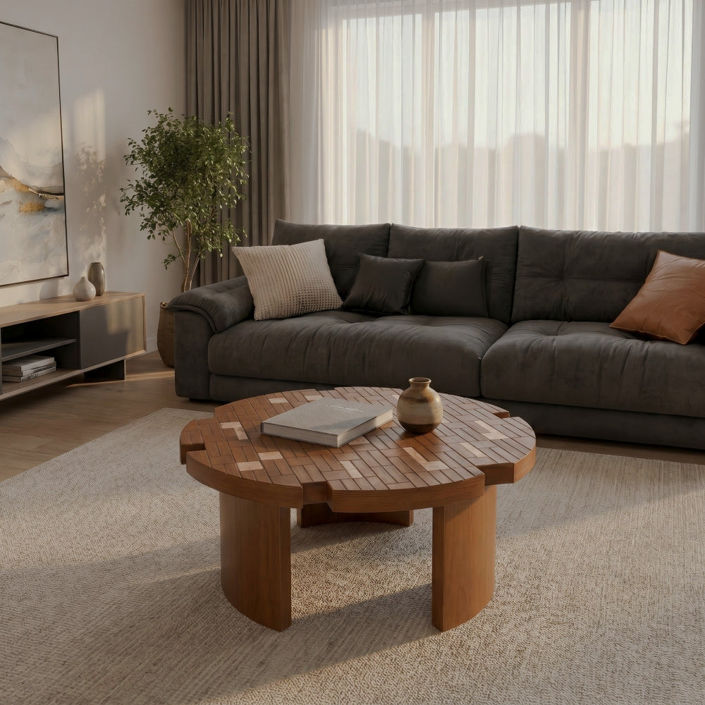 Flower-petal coffee table with patchwork-style top before a dark sofa