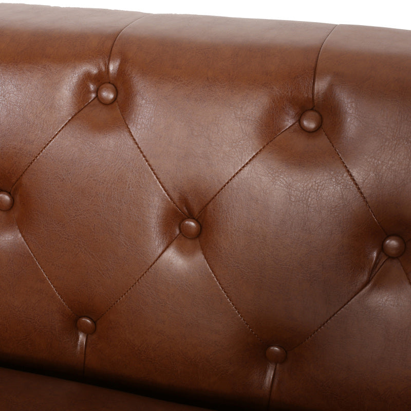 Cognac Button-Tufted Sofa with Bolster Pillows — button tufting and upholstery close-up.
