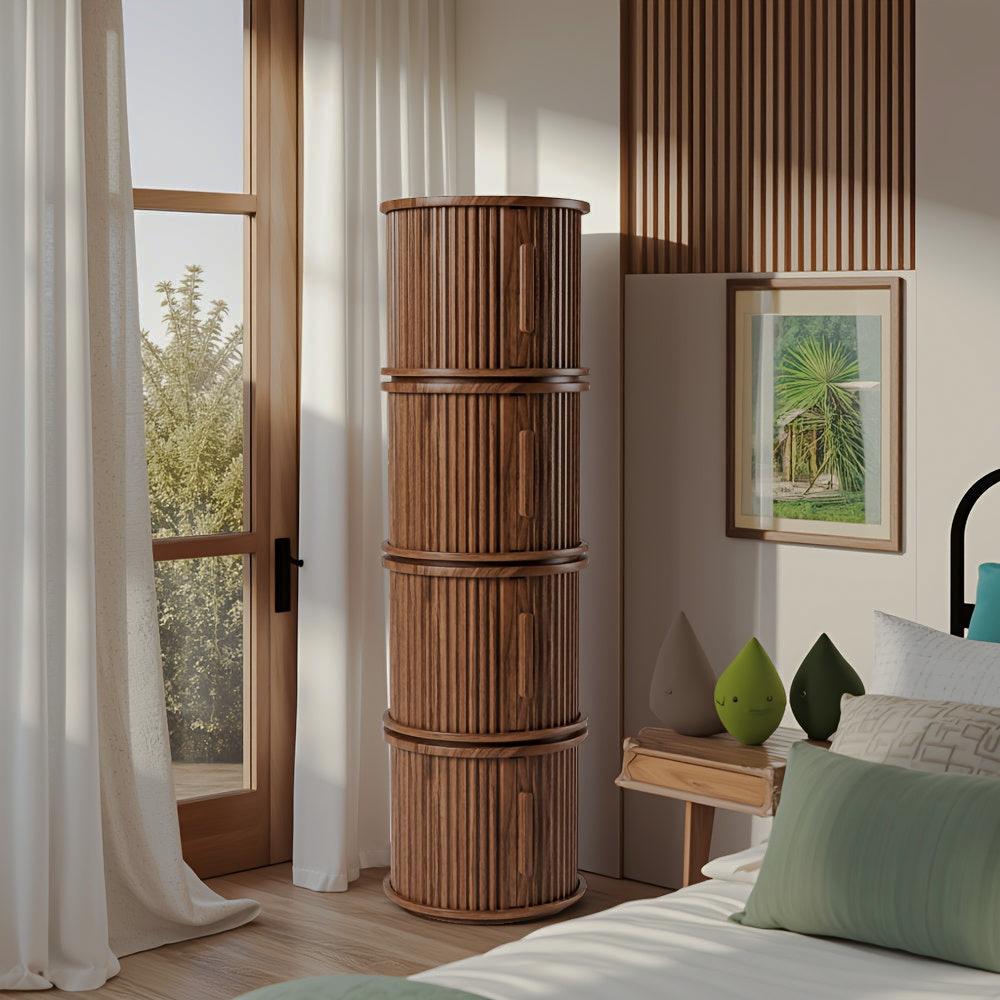 Four round fluted brown storage tables stacked vertically beside a bed and window