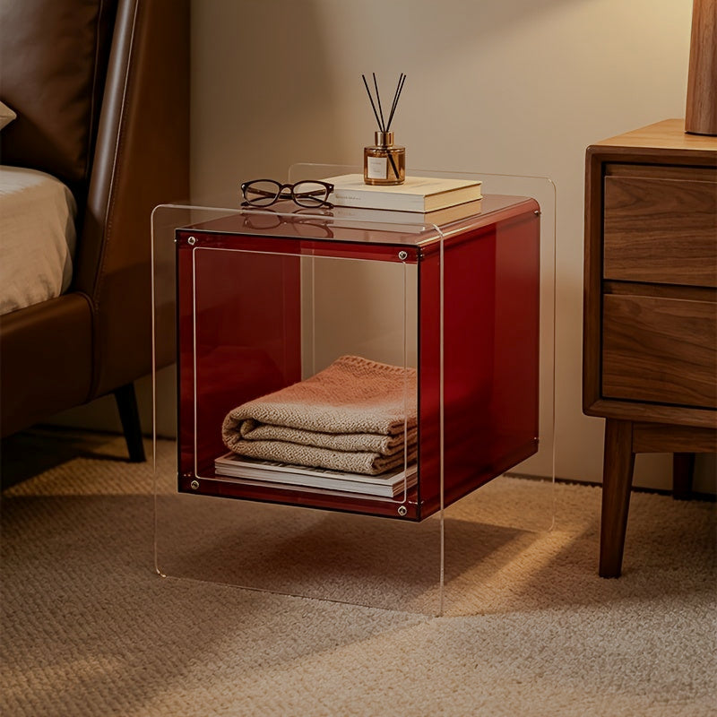 Red acrylic storage side table with folded blankets inside