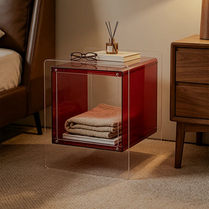 Red acrylic storage side table with folded blankets inside