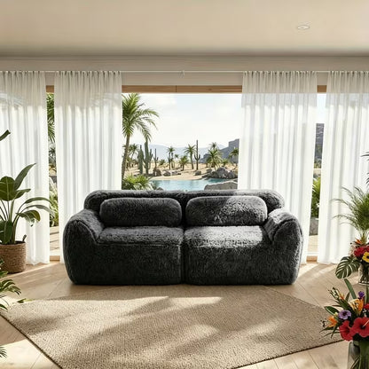 Plush Modular Two-Seat Sofa — dark grey sofa with coastal windows.