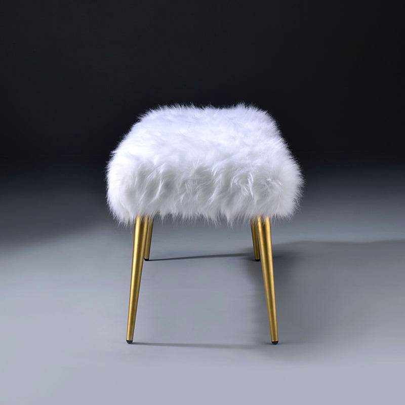End profile of the white faux-fur-style bench with slim gold-tone legs
