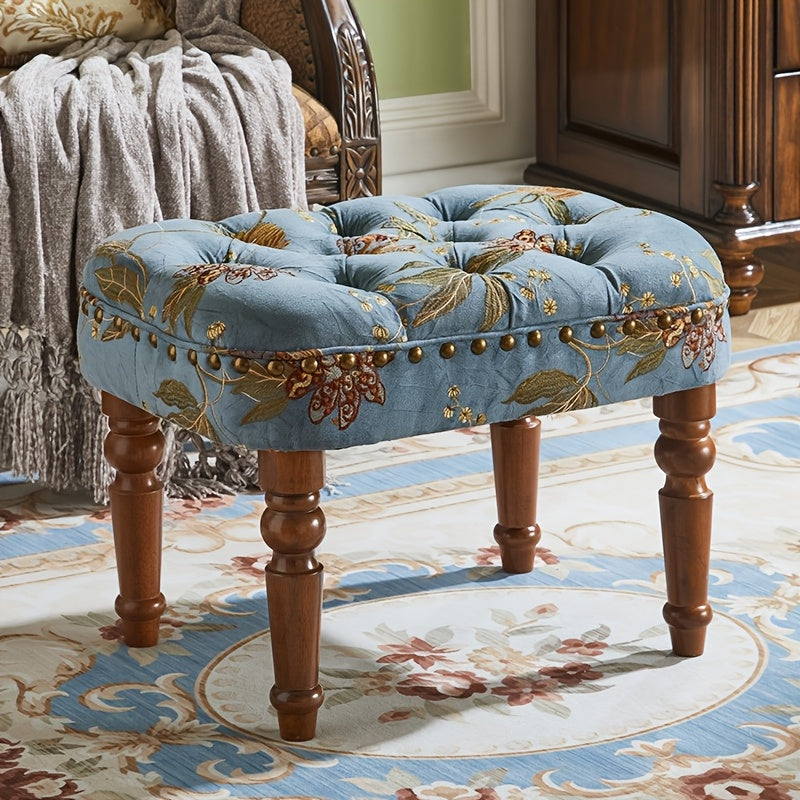 Blue floral tufted rectangular stool with turned wood legs in room