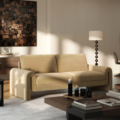 Beige Mason velvet sofa with open arched arms and two seat cushions in a styled living room.