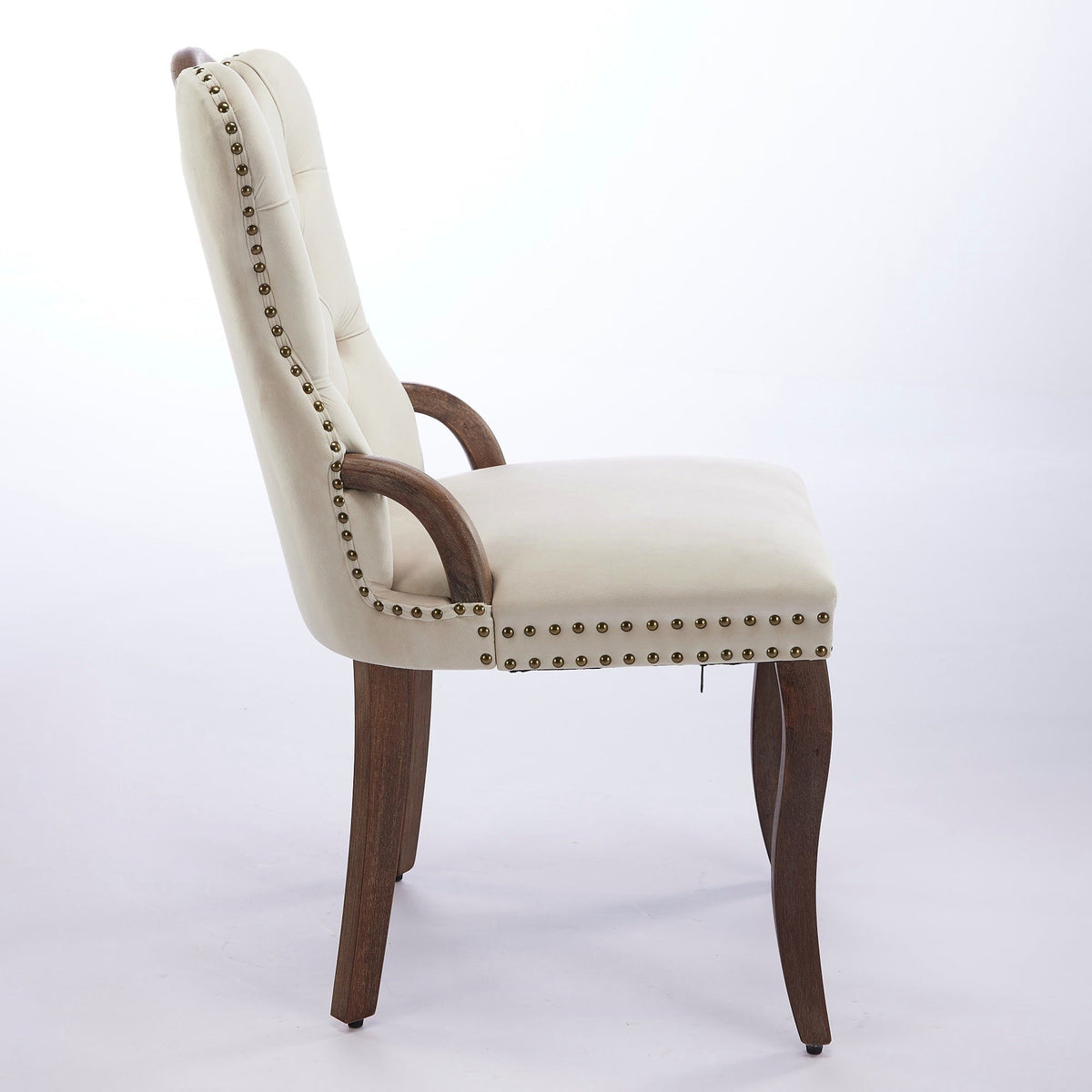 Beige velvet dining chair with a tufted back, wood handle, and curved wood legs