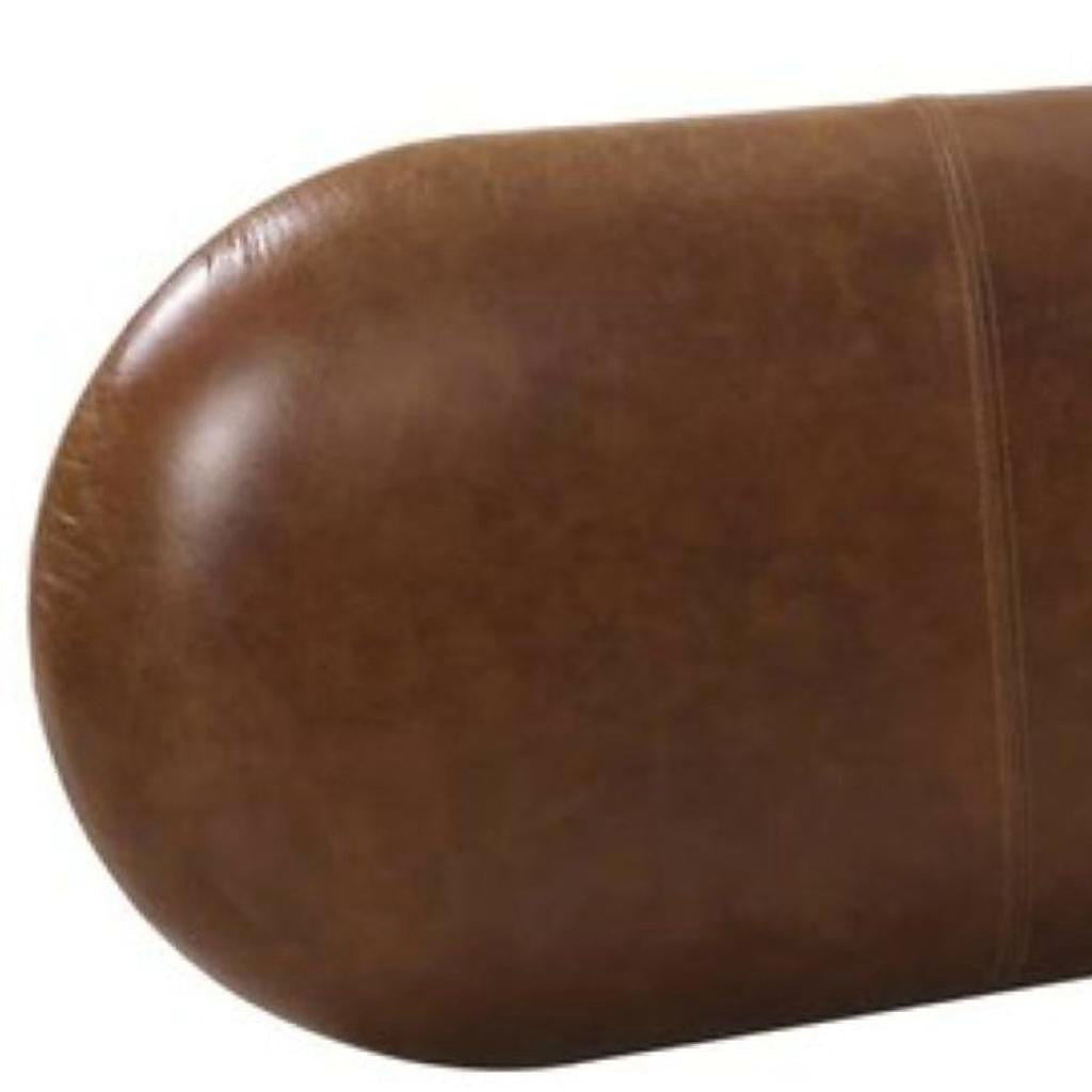 Close view of the brown bench's smooth rounded upholstered seat