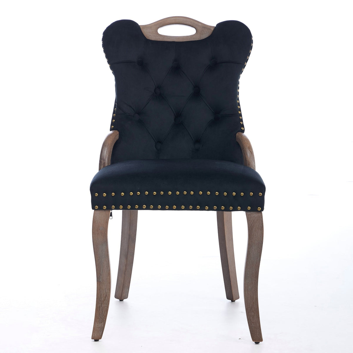 Black velvet dining chair with a tufted back, wood handle, and curved wood legs