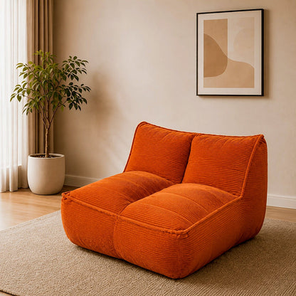 Orange corduroy floor lounge chair with low arms and two-part padded back
