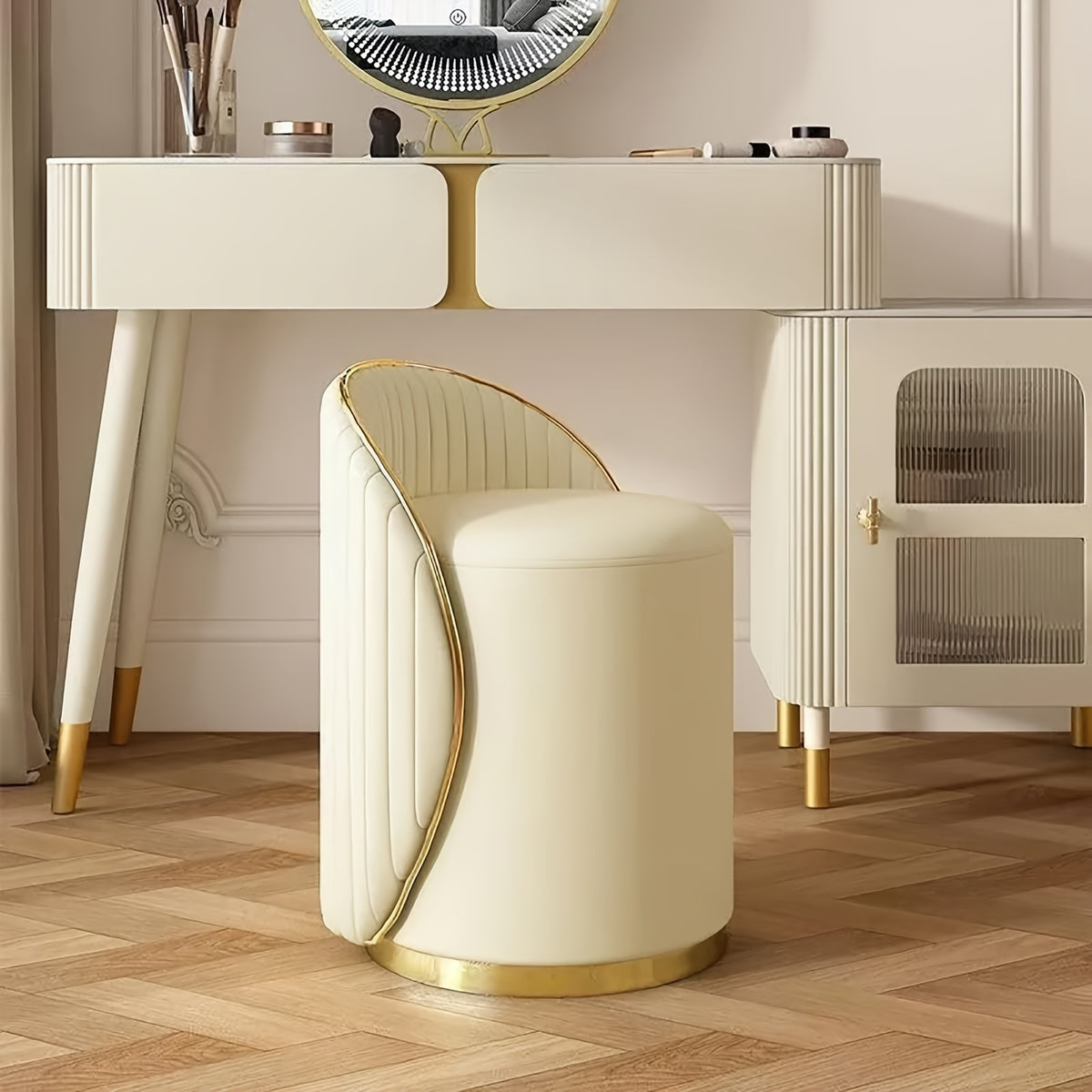 Beige low-back swivel chair at a dressing table with gold-tone accents