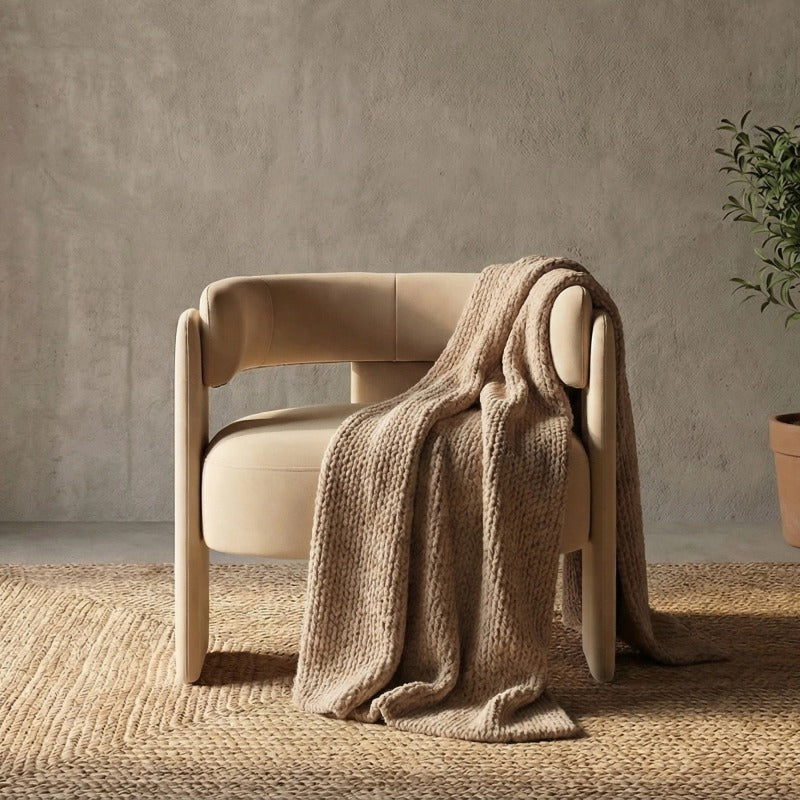 Beige Cutout-Back Velvet Accent Chair — beige cutout-back chair with a throw in a room