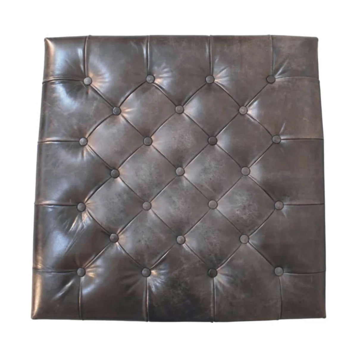 Overhead view of the black ottoman's diamond button tufting