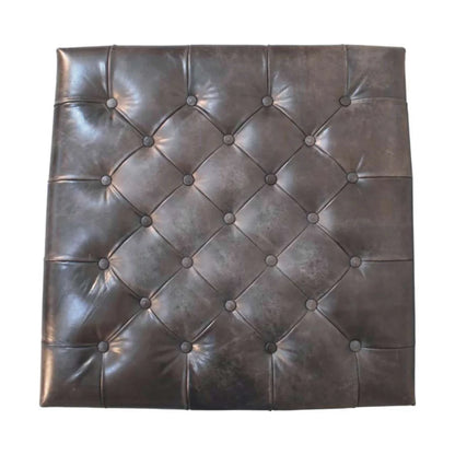 Overhead view of the black ottoman's diamond button tufting