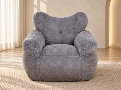 Heart-Back Faux Fur Lounge Chair — grey lounge chair in a living room.
