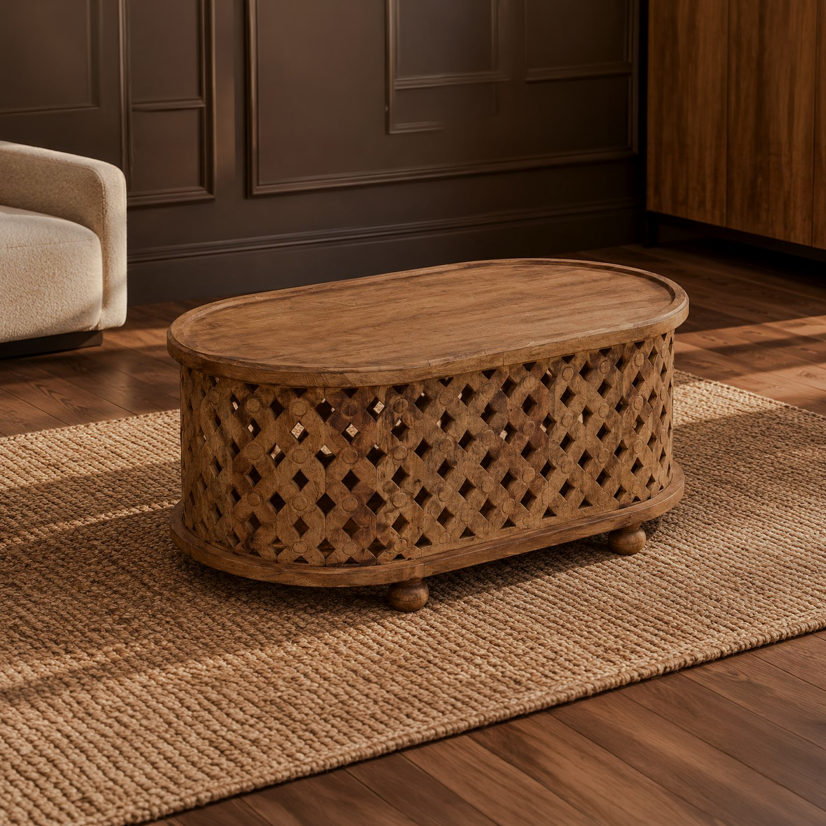 Oval brown coffee table with diamond-cutout sides and rounded feet in a living room