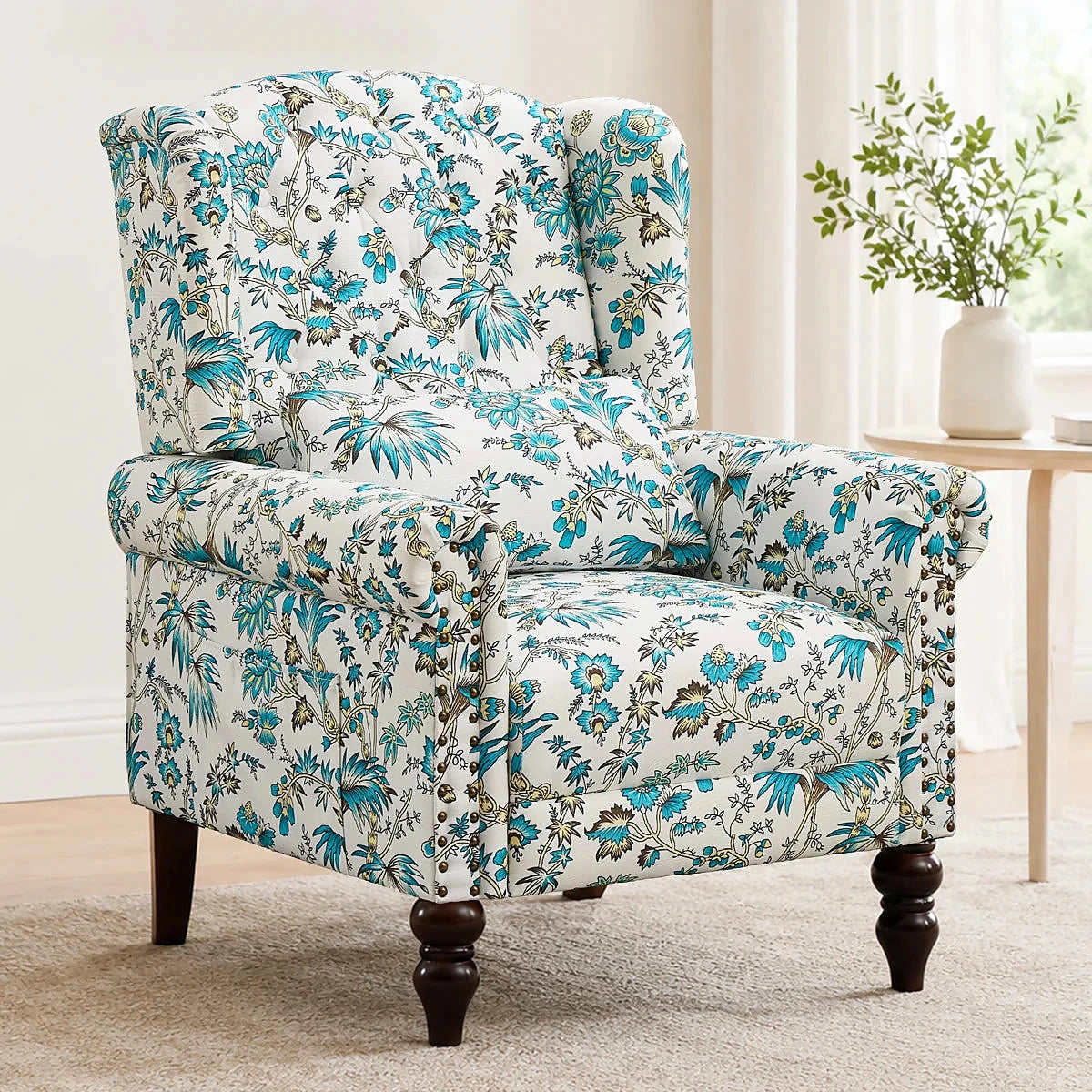 Ivory and blue floral wingback chair with dark wood legs and a side pocket