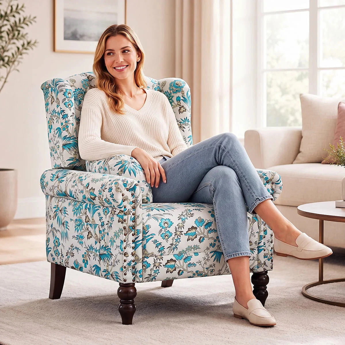 Ivory and blue floral wingback chair with dark wood legs and a side pocket