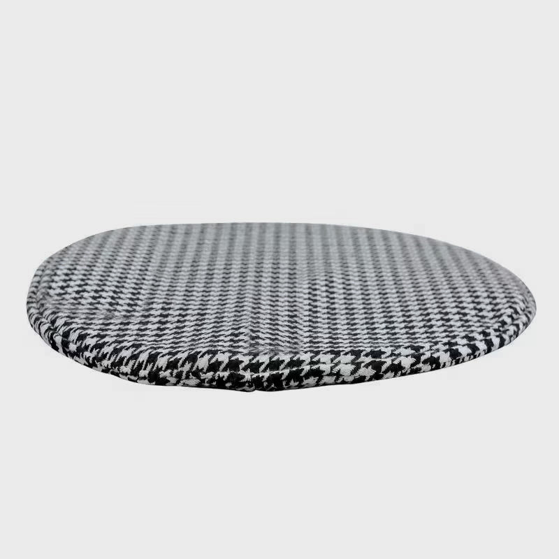 Round black-and-white houndstooth cushion for the cat-cubby table on a white background