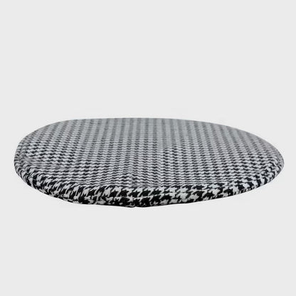 Round black-and-white houndstooth cushion for the cat-cubby table on a white background
