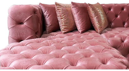 Close-up of Madelene pink velvet button tufting and accent pillows
