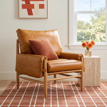 Strap-Detail Wood-Frame Accent Chair — caramel chair with a natural wood frame in a living room