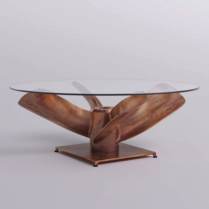 Round clear tabletop above the copper-tone propeller base