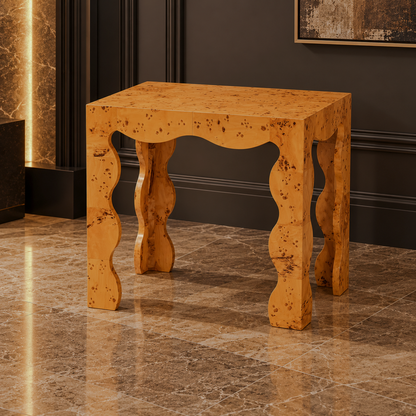 Burl-pattern end table with a scalloped apron and curved legs in a warm-toned room