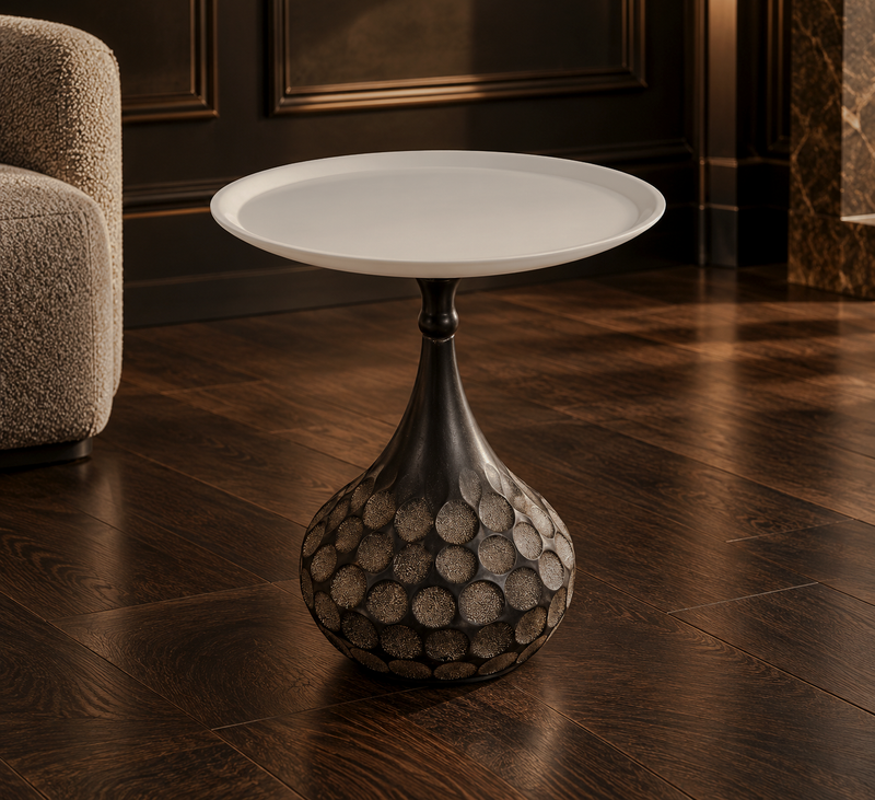 White round-top side table with a dark hammered pedestal in a living room