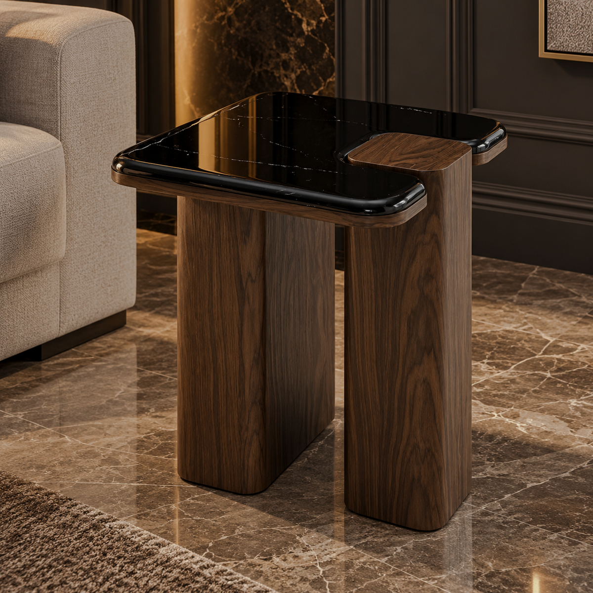 Black marble-look end table with rounded square top and dark brown split-panel base beside a cream armchair