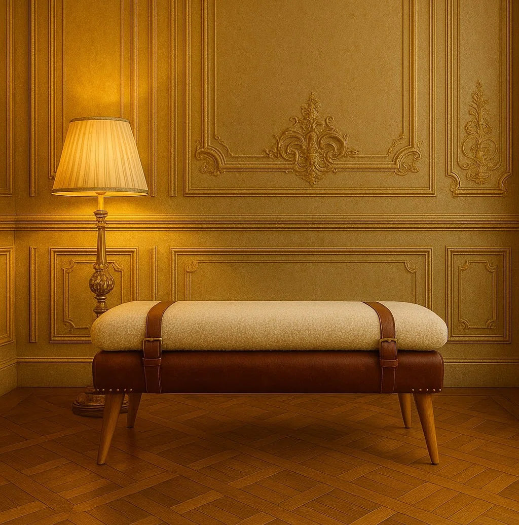 Cream and brown strap-detail bench with tapered legs in a warm paneled room