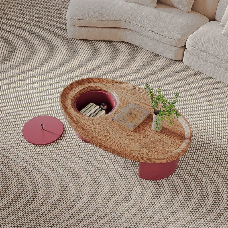 Oval coffee table with the red lid removed to reveal hidden storage
