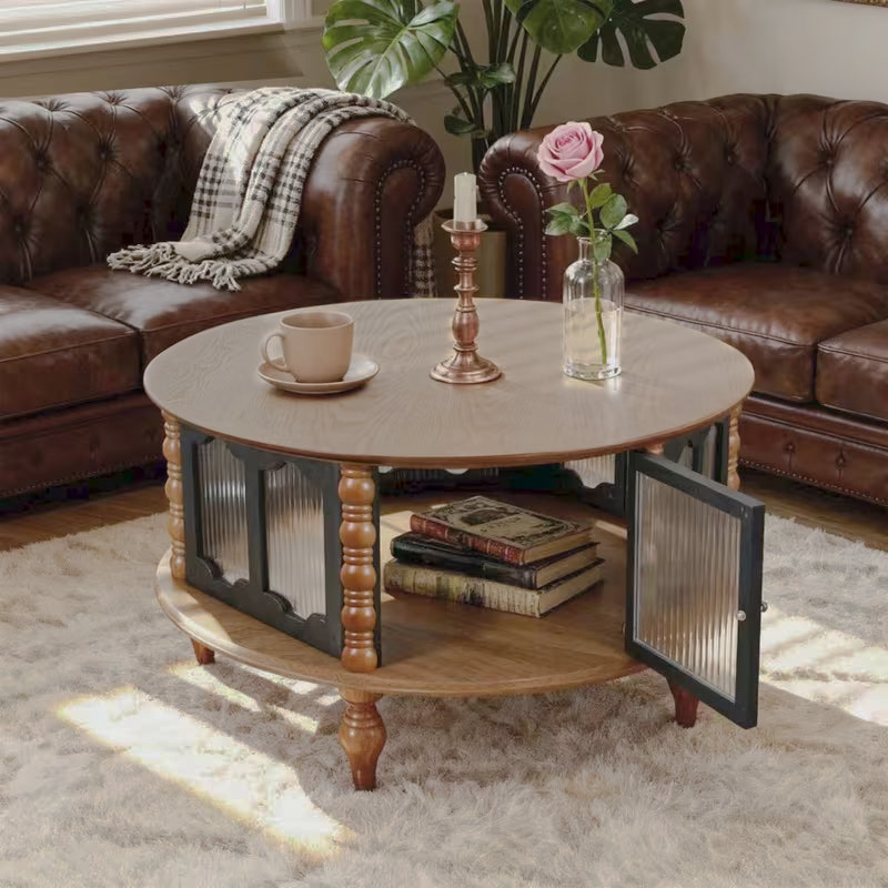 Round storage coffee table with an open door beside a tufted brown sofa