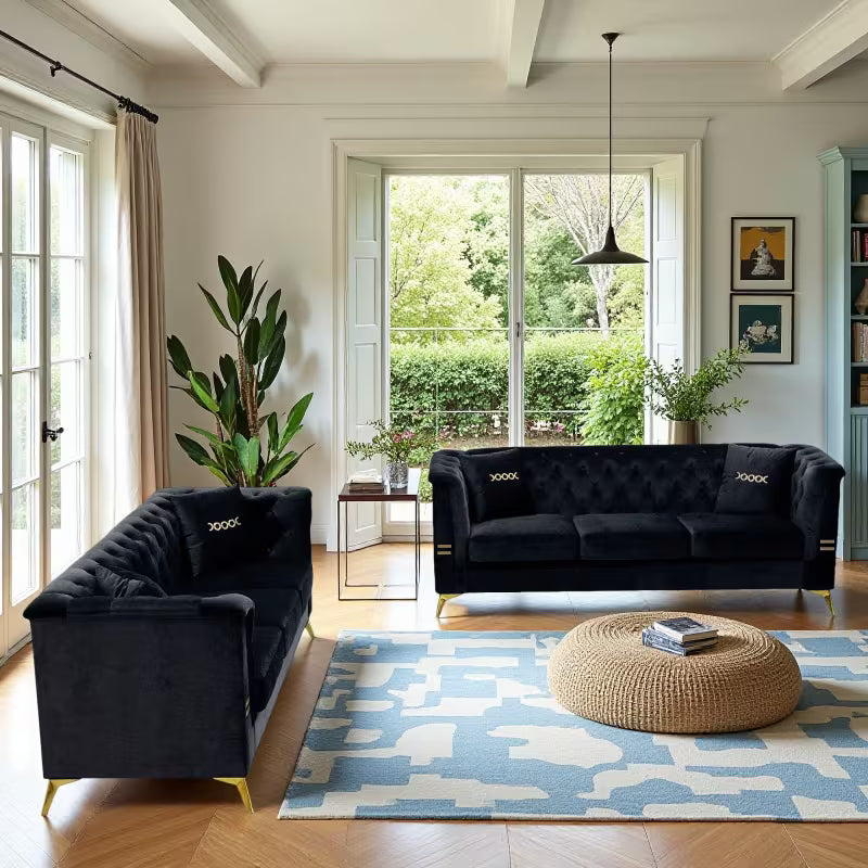 Black Velvet Two-Sofa Set — two-sofa arrangement with blue rug.