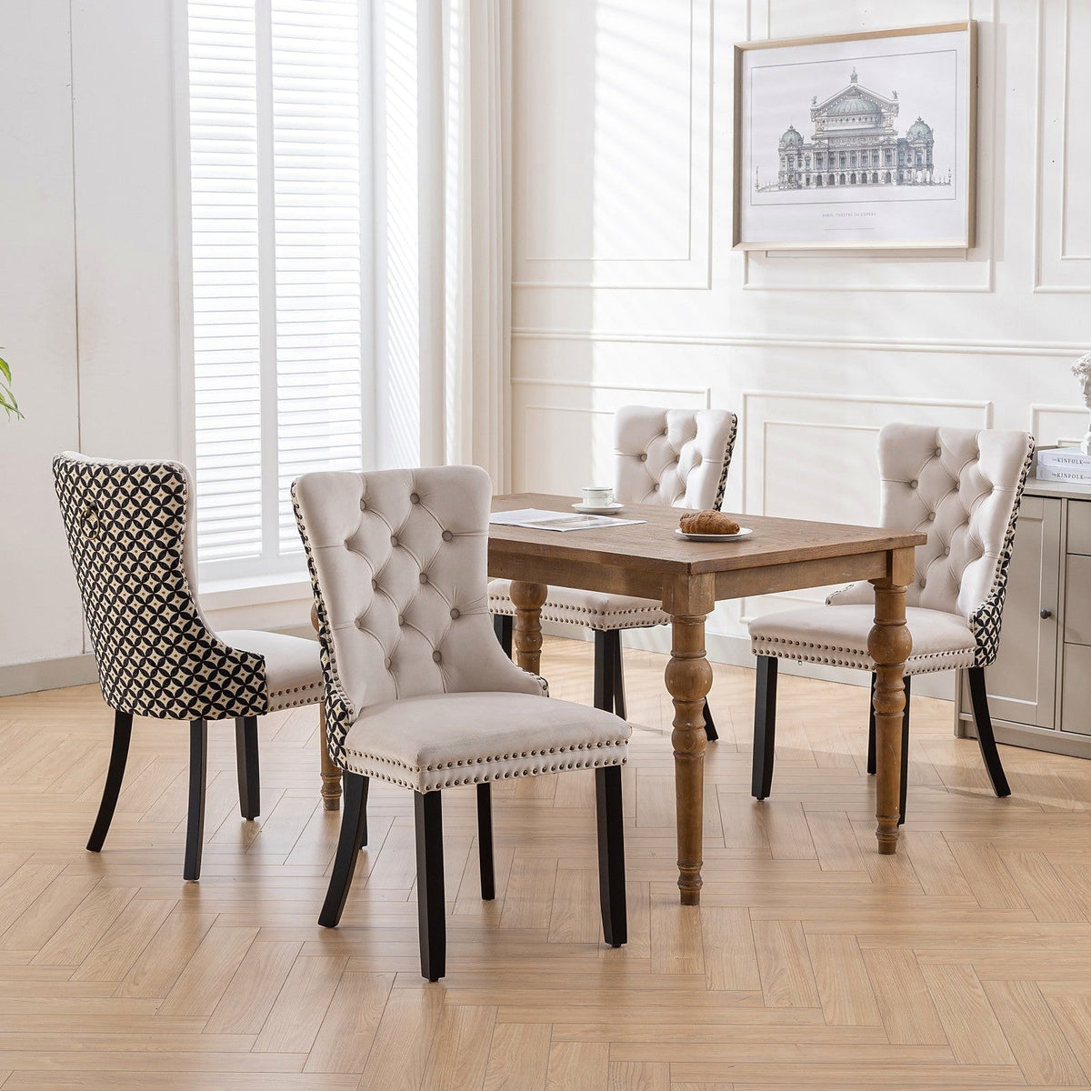 Beige velvet dining chair with a patterned back and dark wood legs