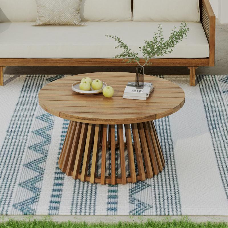 Round slatted-top patio table with a flared slatted base in front of a sofa
