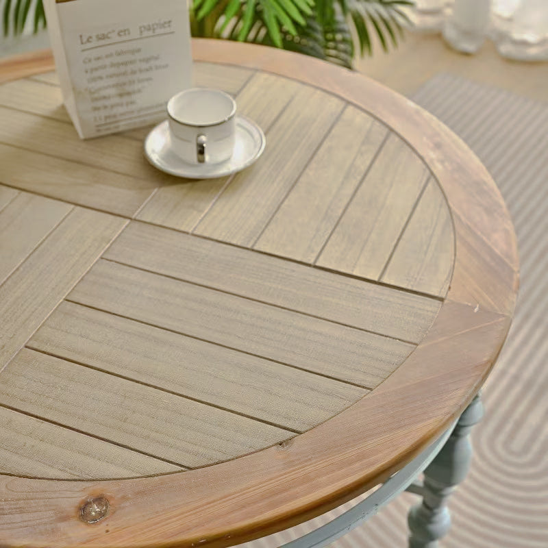 Close-up of the round tabletop with natural wood-look plank pattern and contrasting rim