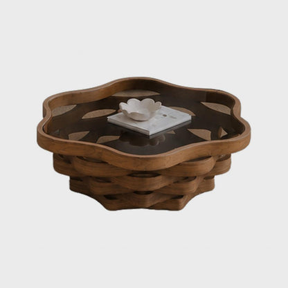 Angled studio view of the cloud-shaped coffee table styled with books and a bowl