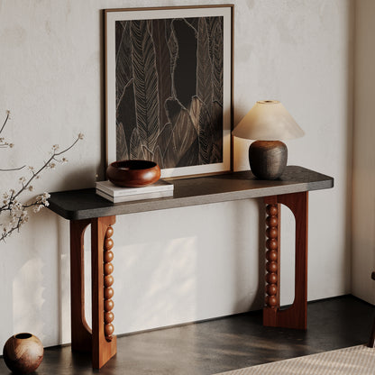 Angled room view of the dark-top console and beaded brown base.
