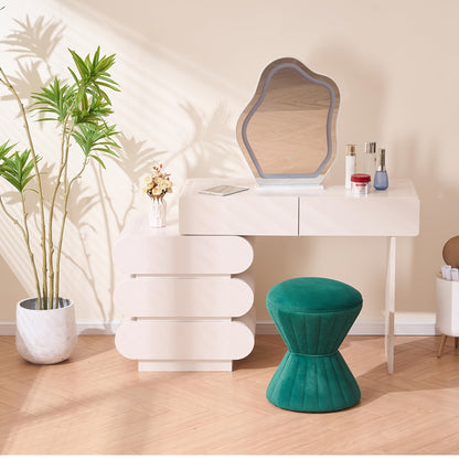 Green velvet ottoman styled at a makeup table