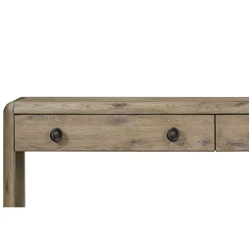 Close view of the knotty oak console drawer fronts, dark circular pulls and rounded edge