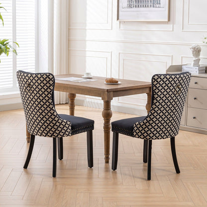 Black velvet dining chair with a patterned back and dark wood legs
