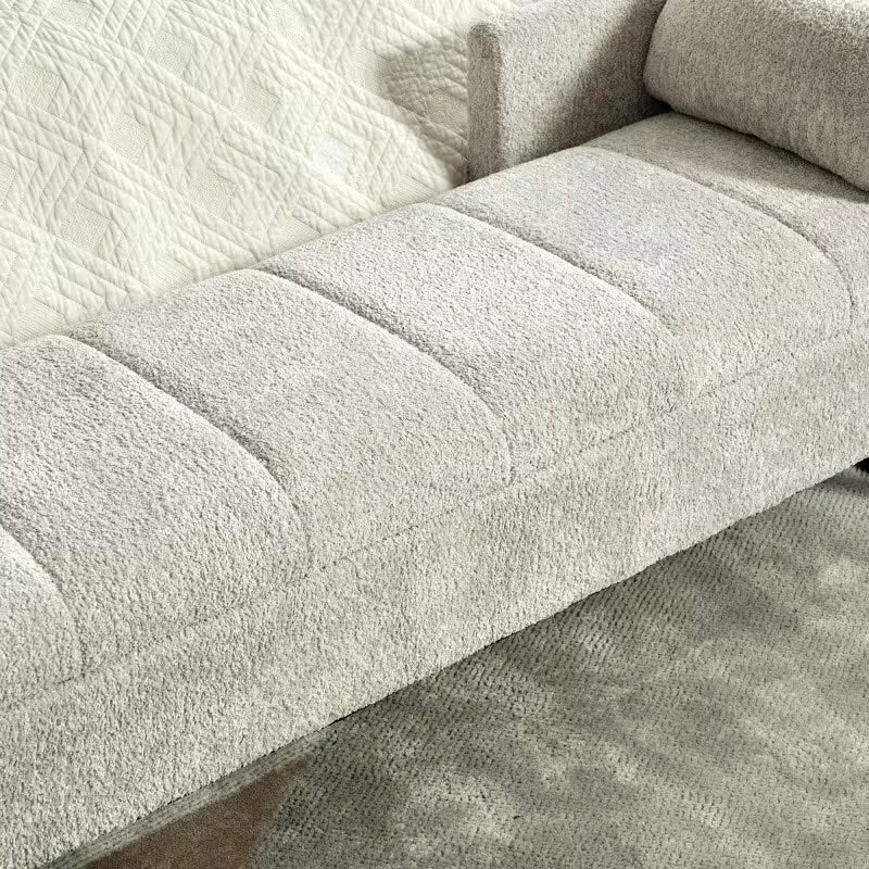 Close view of the light gray textured upholstery and curved stitching on the padded seat