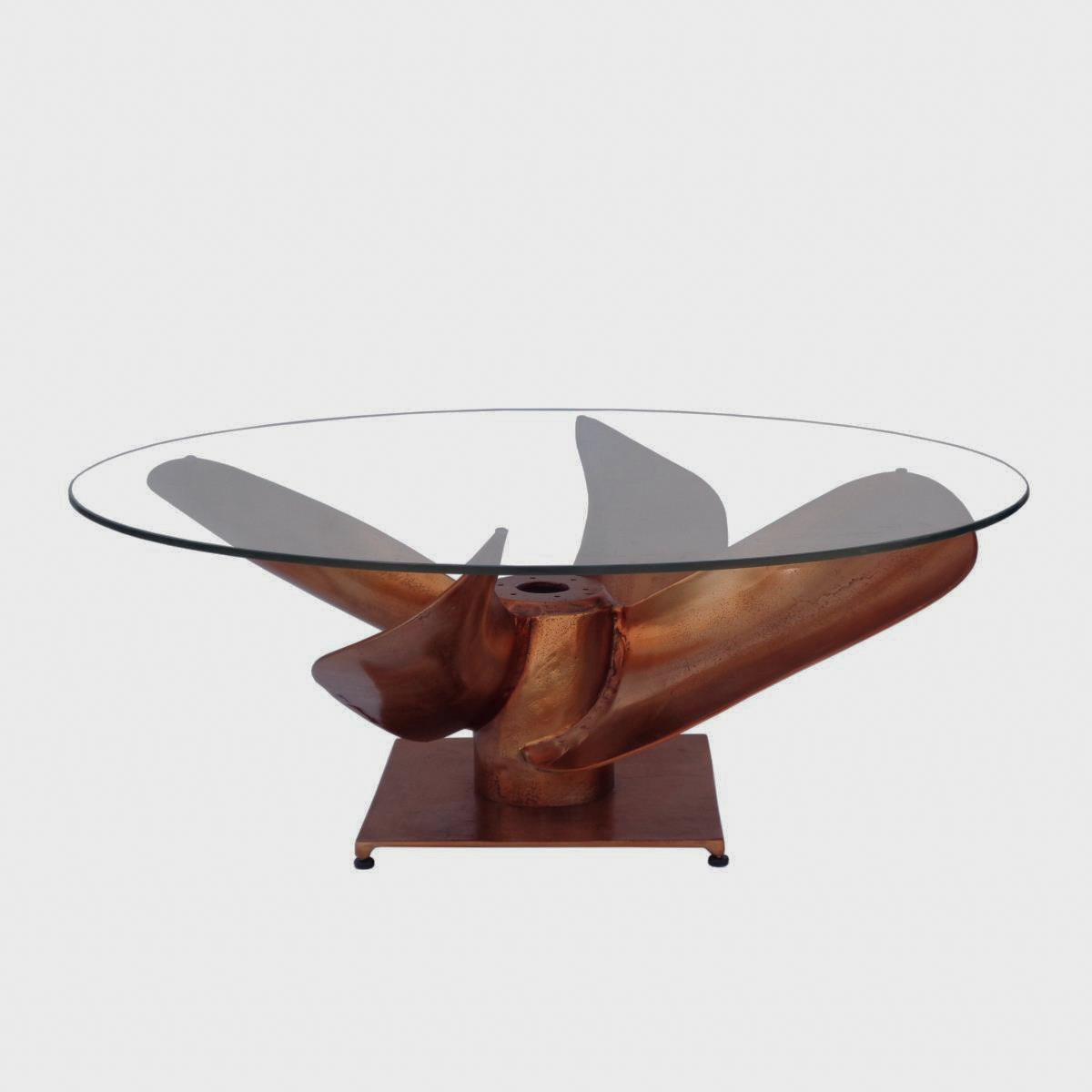 Archimedes coffee table with a propeller-shaped copper-tone base on white