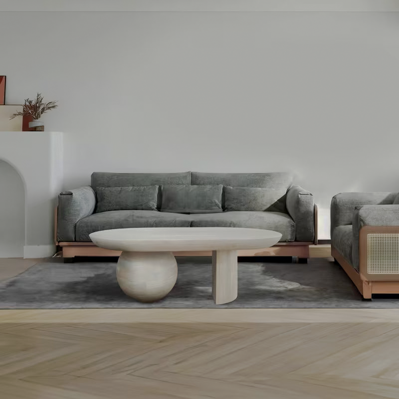 Oblong washed-white coffee table in front of a gray sofa