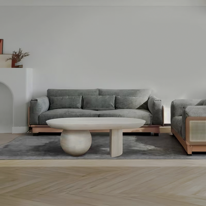 Oblong washed-white coffee table in front of a gray sofa
